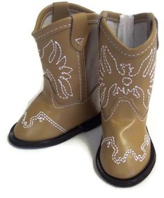 a pair of brown cowboy boots with white stitching