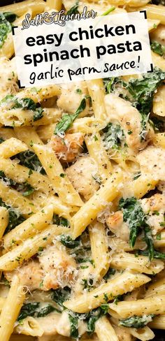 a pasta dish with chicken and spinach in a white sauce on a black plate