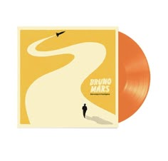 an orange vinyl album cover with a man walking down a winding road in the distance