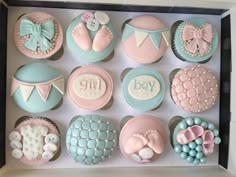 a box filled with lots of cupcakes covered in fondant and decorated to look like babies