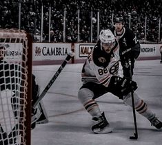 two hockey players are playing on the ice