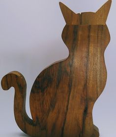 a wooden cat statue sitting on top of a table