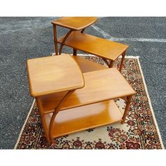 three wooden tables sitting on top of a rug