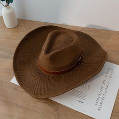 Discover the Perfect Blend of Style and Functionality Step out in style this summer with our New Design Natural Paper Western Cowboy Hat. Whether you're heading to the beach, a music festival, or just enjoying a sunny day outdoors, this hat is your ultimate accessory. Crafted with a blend of natural paper and polyester, it offers a lightweight and breathable fit, making it ideal for warm weather. Versatile and Unisex This cowboy hat is designed for both men and women, offering a unisex appeal that fits seamlessly into any wardrobe. Its solid pattern and casual style make it a versatile piece that complements any outfit, whether you're going for a laid-back beach look or a more polished summer ensemble. Key Features Material: Natural paper and polyester for a lightweight, breathable feel. B Fedora Panama Hat For Beach Season, Panama Fedora Hat For Beach Season, Summer Outdoor Hat With Short Brim, Trendy Fedora Sun Hat For Outdoor, Outdoor Summer Hat With Curved Brim, Casual Brown Sun Hat For Rodeo, Outdoor Summer Hats With Curved Brim, Summer Outdoor Hats With Curved Brim, Brown Fedora With Upf 50+ For Summer