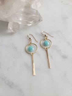 Nova Earrings featuring the Amazonite stone. These gems are such a pretty color! They are light and can be worn with a t-shirt and jeans or with a summer dress. The materials are your choice of 14k Gold Filled or Sterling Silver. Each piece is hammered for texture and shape. The length of the earrings are about 2 in. These are handmade and may vary slightly as well as the stones as they are natural. Thank you! Dainty Everyday Earrings For Summer, Dainty Summer Earrings, Summer Everyday Pierced Earrings, Everyday Summer Pierced Earrings, Minimalist Sterling Silver Earrings For Summer, Summer Everyday Dangle Jewelry, Sterling Silver Earrings For Everyday Summer Wear, Minimalist Round Earrings For Summer, Everyday 14k Gold Filled Gemstone Earrings