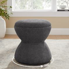 the foot stool is made out of grey fabric