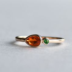 Mexican fire opal paired with Tsavorite garnet in 14k gold 14k solid yellow gold Stone size: 4mm x 6mm Fire opal Side stones: 2mm Tsavorite garnet LEAD TIME: Made to order will take 10-14 days. All of our jewelry will arrive in custom packaging ready for gift giving. FOLLOW US ON: Instagram: @roseandchoc Facebook: /Roseandchoc Pinterest: @Roseandchoc Bezel Band, Sterling Silver Opal Ring, Space Rings, Trio Ring, Silver Opal Ring, Crystal Table, Mexican Fire Opal, Tsavorite Garnet, Fire Opal Ring