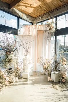 the room is decorated with flowers and branches