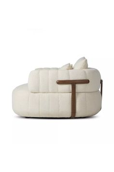 a white couch sitting on top of a wooden table