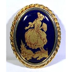 Limoges France Brooch Gold Tone Cobalt Blue Vintage Signed In great condition. Gold tone frame with rope design around the perimeter holds a cobalt blue and gold cabochon portraying a lady with a fan. Signed Limoges France on back of brooch. Measures approximately 1.25 x 1 x .25 inches. PIN0018 Formal Blue Cabochon Brooch, Blue Cabochon Brooch For Formal Occasions, Ceramic Gifts, Limoges France, Rope Design, Blue Vintage, Blue And Gold, A Lady, Vintage Signs