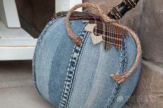 a denim pumpkin sitting on top of a stone wall