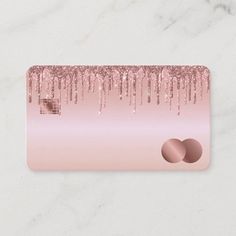 a pink and gold business card with icing on the front, two circles in the middle