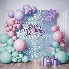 a birthday card with balloons and presents on the floor in front of an arch that says happy birthday