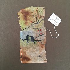 a piece of paper with two birds on it and a tag attached to the side