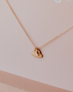 Initial Hearts Necklace Show some love with our Initial Hearts necklace. Perfect for wearing alone or stacking with our other Every Day Collective Co. necklaces and chokers. Made in both 14k Gold Fill or Sterling Silver. To find your perfect length, we suggest using a ruler and a piece of string that hangs naturally like a necklace to determine your desired length. Please indicate your initials of choice in the box above! One initial will be stamped per heart. Delicate Tiny Heart Necklaces, Minimalist Everyday Charm Necklace With Heart Charm, Minimalist Tiny Necklaces For Valentine's Day, Dainty 14k Gold Charm Necklace With Heart Charm, Minimalist Everyday Charm Necklace With Heart, Minimalist Everyday Necklace With Heart Charm, 14k Gold-filled Heart Necklace With Heart Charm, Tiny Heart Necklace In Minimalist Style, Everyday Heart Charm Pendant Necklace