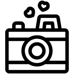 a camera with hearts floating out of it's front and the lens on top