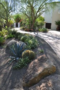 a rock garden in front of a house