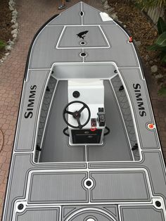 the inside of a small boat with steering wheel