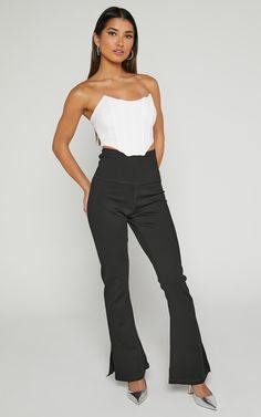 Step up your style game with our Beau Pants. These high-waisted, full-length skinny leg pants are the perfect addition to your casual wardrobe. Made from a comfortable and lightweight rayon fabric, these black pants will effortlessly elevate any outfit. The split hem adds a trendy touch while allowing for easy movement. Whether you're heading to brunch or a night out with friends, these versatile Beau Pants have got you covered. Embrace your individuality and show off your fierce fashion sense i Chic Yoga Pants With Elastic Waistband, High-waisted Elastane Pants For Loungewear, Chic 4-way Stretch Bottoms For Loungewear, Elastane Pants With Wide Waistband For Loungewear, Versatile Straight Yoga Pants In Elastane, High Waist High Stretch Casual Pants, Casual High Stretch High Waist Pants, High Stretch High Waist Casual Pants, Black High-waisted Elastane Dress Pants