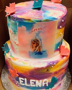 a multi layer cake decorated with an image of a woman