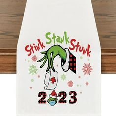 a white towel with the words stink stank and an image of a grin on it