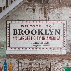 a sign on the side of a building that says, welcome to brooklyn 4 / 4 largest city in america