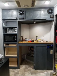 a kitchen area with an oven, microwave and cabinets