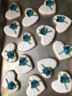 decorated cookies in the shape of hearts with blue flowers