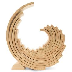 a wooden sculpture made out of several pieces of wood, with the shape of a spiral