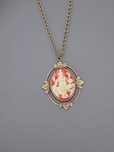 "Vintage Jewelry - Pendant Necklace - Elephant Necklace - Ganesha Necklace - Brass jewelry - Orange and White Necklace - handmade jewelry This is an extraordinary piece. A cameo of the beloved Ganesha embellishes the front of this vintage brass pendant. This resin cameo is orange and soft white. It hangs from a fabulous vintage brass ladder chain. Chloe says,\"Wear it and feel fabulous!\" The pendant measures nearly 2\" long. You can choose the necklace length you would like at checkout. Thanks Bohemian Cameo Jewelry For Gifts, Bohemian Cameo Jewelry Gift, Red Cameo Necklace For Gift, Red Cameo Jewelry Gift, Bohemian Cameo Necklace For Gift, Ganesha Necklace, Bainbridge Island, Egyptian Jewelry, Elephant Necklace