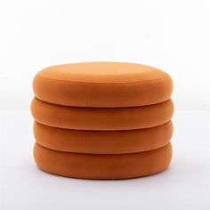 four round orange cushions stacked on top of each other