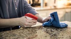 a person wiping their hands with a cloth on top of a kitchen counter stock photo