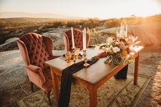 a wooden table topped with candles and flowers