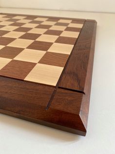 a wooden chess board sitting on top of a table