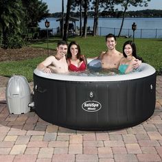 four people are in an outdoor hot tub