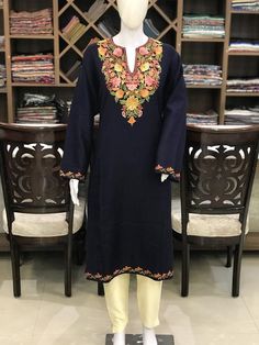 A stunningly marvellous Pheran. This Pheran features intricate Kashmir Aari embroidery on neckline and sleeves.- - - - - - - - - - - - - - - - - - - - Product Details- Condition: Brand New (made to order)- Style: Pheran Tunic- Fabric: Wool- Colour: Navy Blue- Embroidery: Aari Work- Embroidery Colour: Multi-Colour- Standard Length: 40" - Care Instructions: Dry Clean Only.**If you want the Tunic to be shorter or longer, just send us a message, and we will tailor it accordingly.Sizing- Please selec Traditional V-neck Kurta With Chikankari Embroidery, Traditional V-neck Kurta With Dabka Work, Traditional V-neck Kurta For Festive Occasions, V-neck Traditional Wear With Chikankari Embroidery, Anarkali Tunic With Floral Embroidery, Straight Kurta With Multicolor Intricate Embroidery, Semi-stitched Multicolor Embroidery Dress With Long Sleeves, Semi-stitched Long Sleeve Dress With Multicolor Embroidery, Traditional Free Size Dress For Eid