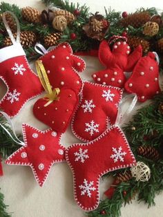 christmas ornaments are arranged on the floor next to pine cones