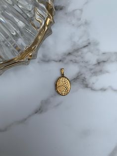 The vintage rolled gold round locket is a timeless piece that exudes elegance and charm. Made with meticulous craftsmanship, this locket showcases a classic heart-shaped design, capturing the essence of romance and sentimentality. The rolled gold finish gives it a warm and luxurious glow, reminiscent of the vintage era. Its compact size makes it perfect for holding cherished memories and loved ones close to your heart. Whether worn as a symbol of love, a personal talisman, or a beautiful accesso Gold Round Pendant Locket Necklace With Charms, Gold Round Locket Necklace With Charms, Gold Engraved Round Disc Locket Necklace, Gold Locket Necklace With Round Disc, Elegant Gold Round Disc Locket Necklace, Elegant Gold Locket Necklace With Charms, Gold Round Locket Necklace, Gold Round Disc Locket Necklace, Diamond Pattern Design