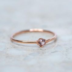 A sweet, fine 6 claw stacking ring set with a pink sapphire. Sapphire measures 3mm. Band width 1.2mm. Weight 0.9g approx. Pictured here with a high shine finish. For a matte finish please leave a note at checkout. Dainty Rose Gold Sapphire Birthstone Ring, Minimalist Rose Gold Sapphire Ring Birthstone, Minimalist Rose Gold Sapphire Promise Ring, Rose Gold Pink Sapphire Birthstone Promise Ring, Rose Gold Sapphire Promise Ring In Minimalist Style, Minimalist Rose Gold Sapphire Ring, Dainty Sapphire Ring In Rose Gold, Rose Gold Stackable Rings With Pink Sapphire As Gift, Rose Gold Pink Sapphire Stackable Rings As Gift