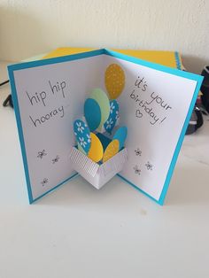 a pop up birthday card with balloons inside