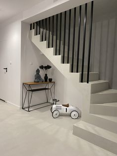 a room with white walls and black railings