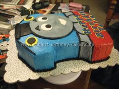 a thomas the train birthday cake is on top of a table with many other items