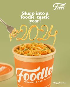 a cup with noodles in it and a fork sticking out of the top that says foodie