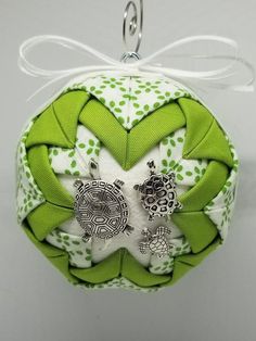 a green and white ornament hanging from a hook