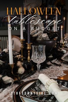 a table set for halloween with candles and place settings