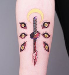 a tattoo on the leg of a woman with an arrow and eyeballs around it