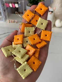 small crackers are being held in the palm of someone's hand, with string attached to them