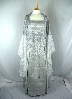 This listing is for a custom made dress,it will be made to the measurements you send me. Please send me a message with your bust,waist and hip measurements,and please measure from the top of your shoulder to the floor with shoes on. It will be made with beautiful silver crushed velvet and stunning grey embroidered bridal brocade. The sleeves are part velvet with a stunning pale silver embroidered lace .It has a corset style front and back with lacing so you can adjust the dress to fit your body Gothic Fitted Corset Wedding Dress, Princess Style Fitted Ball Gown Wedding Dress, Fitted Elven Corset Dress For Costume Party, Fitted Gothic Gown For Fancy Dress, Gothic Fitted Gown For Fancy Dress, Elven Fitted Corset Dress For Costume Party, Gothic Wedding Dress With Fitted Bodice, Fitted Princess Style Floor-length Wedding Dress, Princess Style Fitted Floor-length Wedding Dress