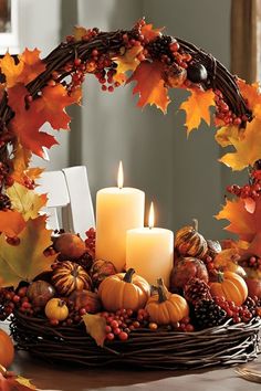 a wreath with candles and autumn leaves