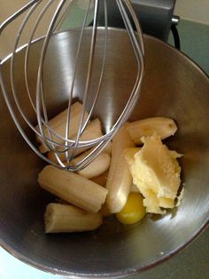 a metal bowl filled with bananas and other ingredients